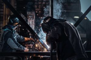 man is working at the busy metal factory 2023 11 27 05 08 01 utc min