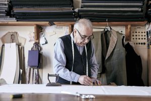 tailor with measuring tape around neck working wit 2023 11 27 05 02 28 utc min